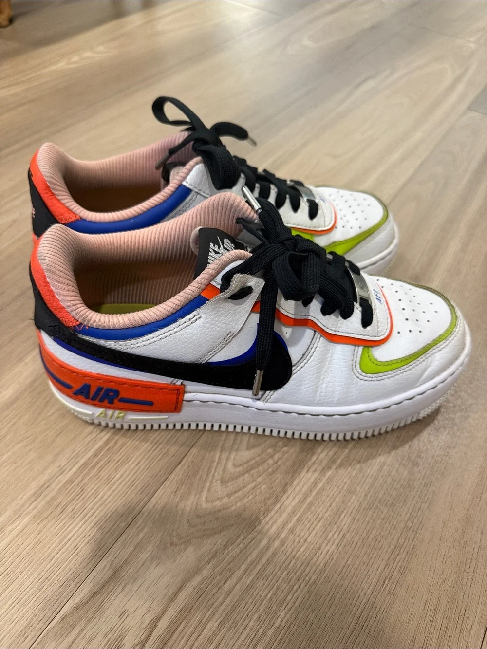 Nike White Low-Top Sneakers with Black Swoosh and Neon Green & Orange Accents
